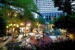 a city street with tables and trees and buildings at Crowne Plaza Chengdu West by IHG in Chengdu