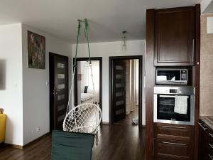 a living room with a couch and a chair in it at Cora Lego Apartment City View near Stadium & Sinfonia Varsovia Optional Parking in Warsaw