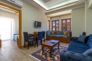 a living room with a couch and a table at Adali Aparts in Side