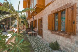 a building with a bench on the side of it at Adali Aparts in Side