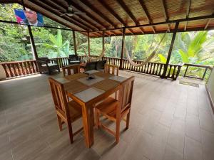 a dining room with a table and chairs on a porch at Pacheco Villa in Drake