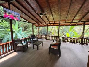 a screened in porch with chairs and a large screen at Pacheco Villa in Drake