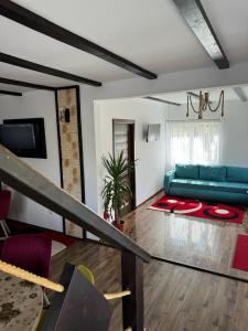a living room with a blue couch and a table at Casa Ilinca Bran in Şimon +15 photos