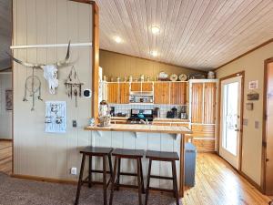 a kitchen with a counter and stools in a room at Cozy Beaver Lake Getaway in Lowell
