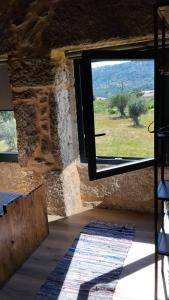 a room with a window with a view of a field at Fuinhas de Amor a 2 in Fuinhas