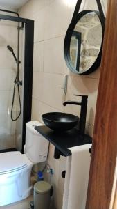 a bathroom with a sink and a toilet and a mirror at Fuinhas de Amor a 2 in Fuinhas