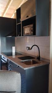 a kitchen with a sink and a counter top at Fuinhas de Amor a 2 in Fuinhas