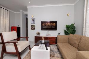 a living room with a couch and a table at Luxury & modern 1 Bedroom apartments in Munyonyo-Kampala in Kampala