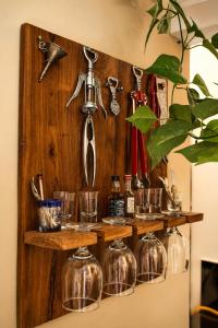 a wooden shelf with glass dishes and a siphon at Apartment Waskaduwa in Waskaduwa