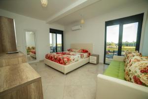 a bedroom with a bed and a couch at Apartments IL GUSTO in Ulcinj