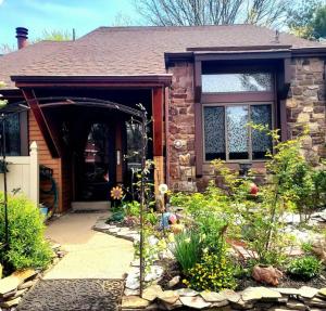 a brick house with a front door and a garden at George School Garden Homestay in Langhorne