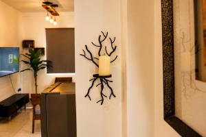 a wall decoration with a candle on a wall at Apartment Waskaduwa in Waskaduwa