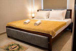 a bedroom with a bed with two pillows on it at Apartment Waskaduwa in Waskaduwa