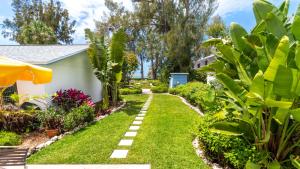 a garden with grass and plants and a pathway at Bamboo Apartments in Holmes Beach +119 photos