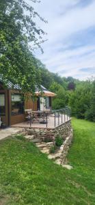 a deck with a picnic table and a building at Tinyhouse am Bach, 3144 Wald in Wald