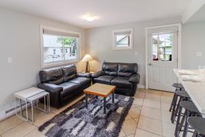 a living room with a couch and a table at Westlake Cottage - Hillier Lodge in Wellington