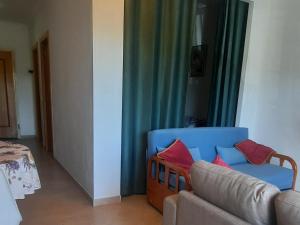 a living room with a couch and a chair at St James Apartment in Luz