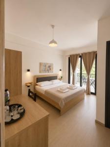 a bedroom with a large bed and a table at Lungomare private rooms in Vlorë