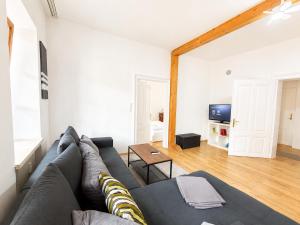 a living room with a couch and a table at KAISERLICH WOHNEN zentral und am Fluss in Bad Ischl