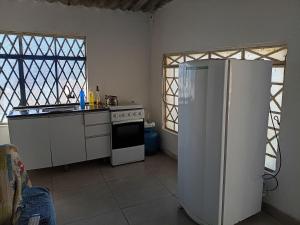 a kitchen with a refrigerator and a stove at Casa Catarina in São Roque