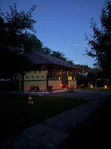 a house at night with the lights on at Casa Drumetului in Comarnic