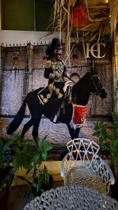 a statue of a man riding a horse next to a chair at Hotel Museo Carnaval in Huejotzingo