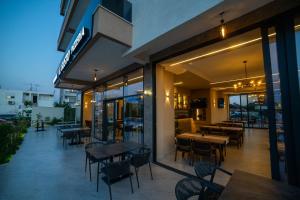 a restaurant with tables and chairs on a patio at Apartments IL GUSTO in Ulcinj