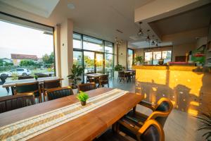 a restaurant with a wooden table and chairs at Apartments IL GUSTO in Ulcinj