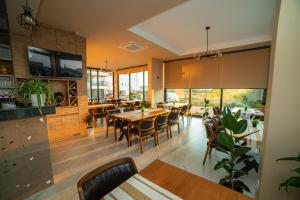 a restaurant with tables and chairs and large windows at Apartments IL GUSTO in Ulcinj
