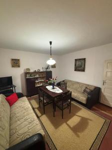 a living room with a couch and a table at Vila Vuković in Leskovac