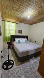 a bedroom with a bed with a camera on a tripod at Hidden Bungalow in Roseau