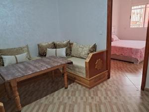 a living room with a couch and a mirror at Centre boukidan in Al Hoceïma