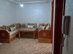 a living room with a couch and a table at Centre boukidan in Al Hoceïma