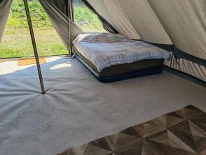 a bed inside of a tent with a mattress at Gallow Hill Campsite in Startforth