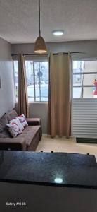a living room with a couch and a window at Townhouse Flat Térreo in Ananindeua +5 photos