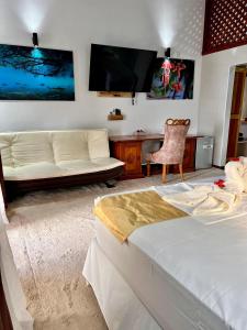 a living room with a bed and a couch at Villa Chez Batista in Takamaka +147 photos