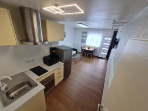a kitchen with a refrigerator and a table in a room at Apartman Ogulin "Klek Escape" in Sveti Petar +6 photos