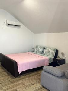 a bedroom with a bed and a couch at Irena Apartment near Aqua Park in Trebinje +29 photos