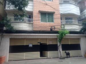 a garage with a dog standing in front of it at One Private Room Near Dhaka Airport in Dhaka