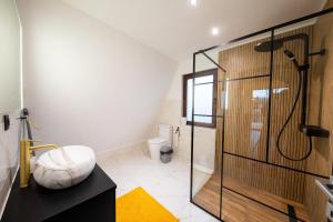 a bathroom with a shower with a glass door at DB Forest Resort in Bucsin +54 photos