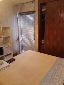 a bedroom with a large bed and a window at Oeiras Central, near Beach & Public Transport in Oeiras