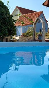 a house with a swimming pool in front of a house at Catapeixe Holiday Apartments in Redondela
