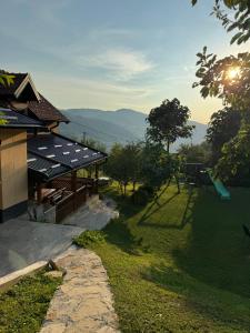 a house with a view of a playground at Villa Lux Nature in Sarajevo