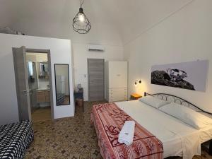 a bedroom with a large bed and a mirror at Struttura Le Gemme in Marettimo
