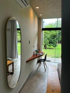 a room with a table and a chair and a mirror at Casa Super Paradise in Rio Tinto +17 photos