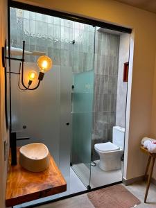 a bathroom with a glass shower with a toilet at Casa Super Paradise in Rio Tinto