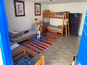 a room with two bunk beds and a table at Villa Azzurra in Imsouane