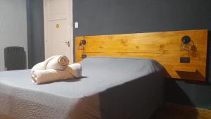 a stuffed animal is sitting on a bed at Mora Hostel in Mendoza