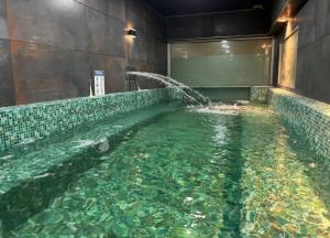 a large pool of water with a fountain at Hotel Playa Brava in Punta del Este +18 photos