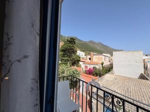 a balcony with a chair and a view of a city at Struttura Le Gemme in Marettimo